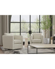 Modern living room with beige armchairs, a coffee table, and a gray sofa.