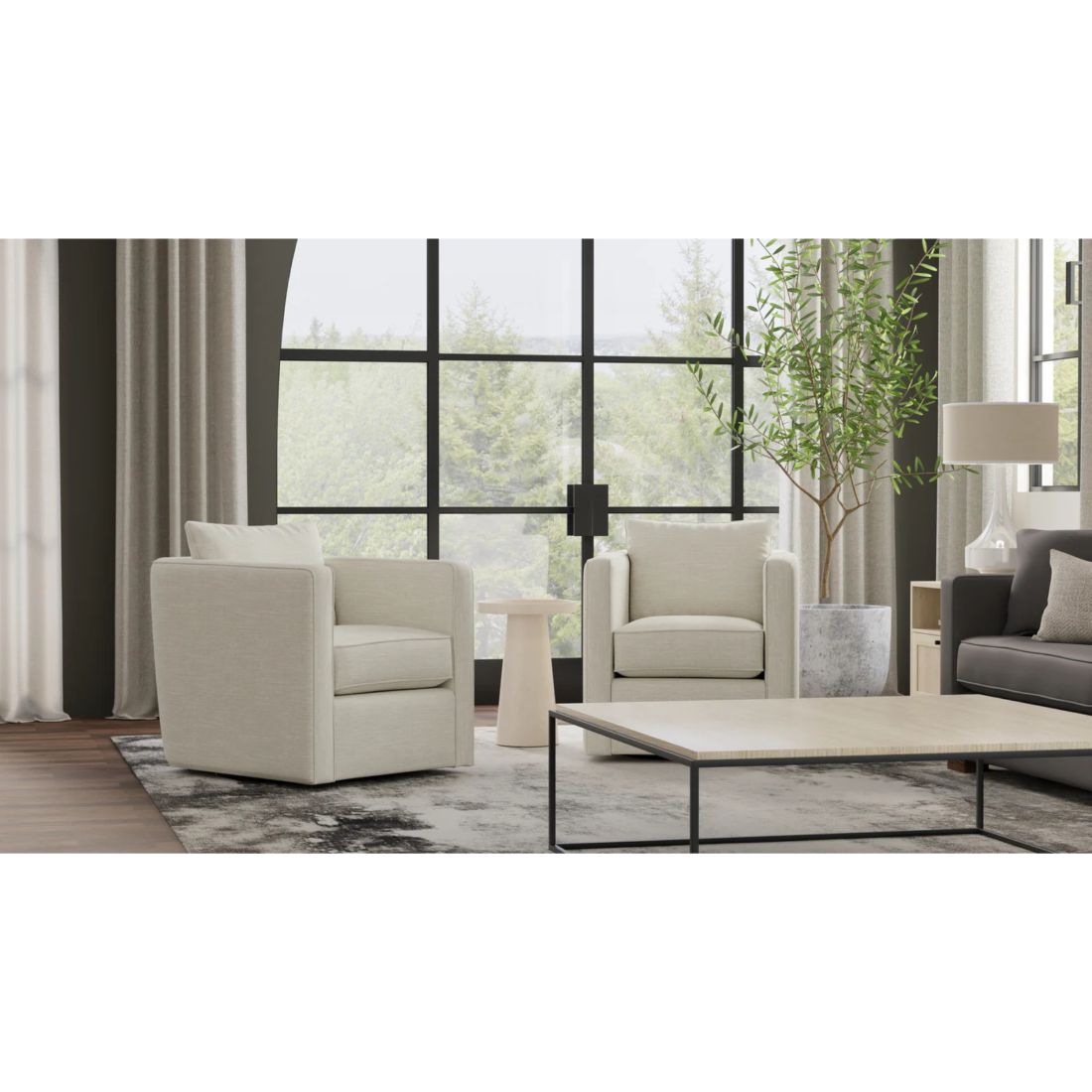 Modern living room with beige armchairs, a coffee table, and a gray sofa.